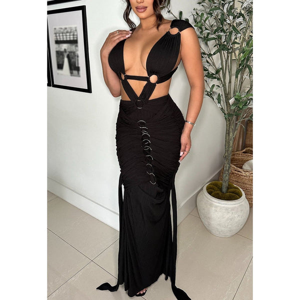 Black Sultry bodycon style maxi dress with intricate strappy design and pleated bodice adorned with silver circular accents . Features back zipper and back adjustable tie closure. 